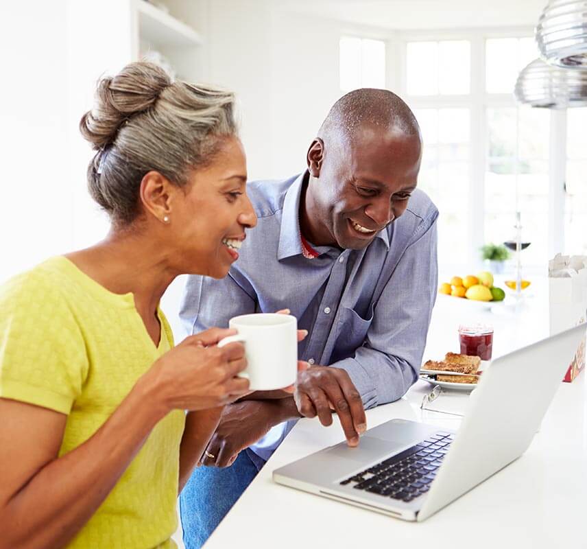 Older man and woman looking at laptop